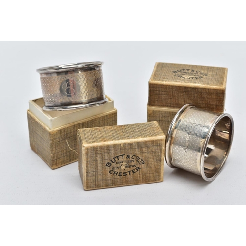 39 - TWO CASED SILVER NAPKIN RINGS each of an engine turn design engraved initial 'E' on one and 'R' on t... 