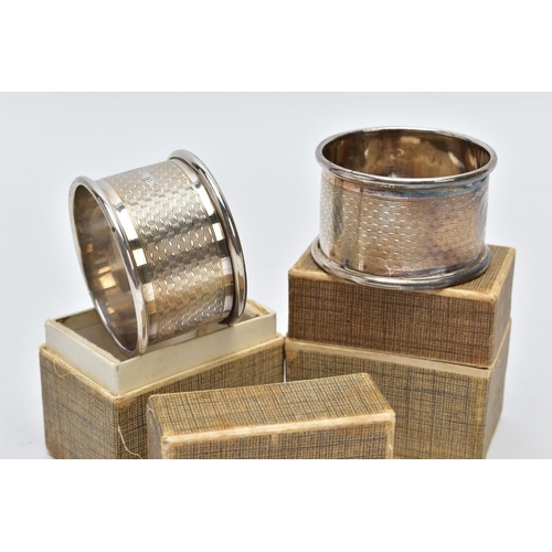 39 - TWO CASED SILVER NAPKIN RINGS each of an engine turn design engraved initial 'E' on one and 'R' on t... 