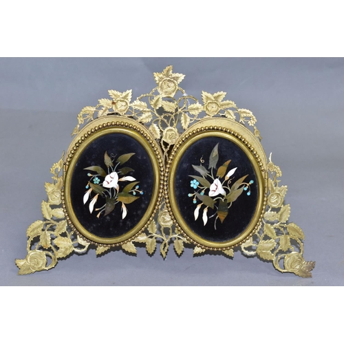 479 - A VICTORIAN GILT METAL AND PIETRA DURA MOUNTED PHOTOGRAPH FRAME, the oval floral panels set within b... 