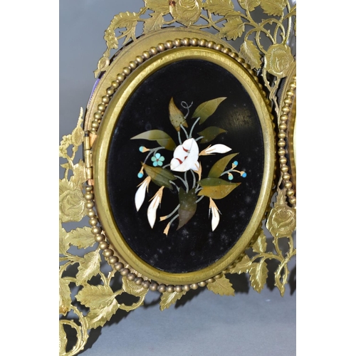 479 - A VICTORIAN GILT METAL AND PIETRA DURA MOUNTED PHOTOGRAPH FRAME, the oval floral panels set within b... 