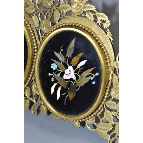 479 - A VICTORIAN GILT METAL AND PIETRA DURA MOUNTED PHOTOGRAPH FRAME, the oval floral panels set within b... 