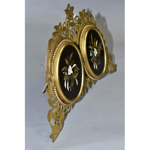 479 - A VICTORIAN GILT METAL AND PIETRA DURA MOUNTED PHOTOGRAPH FRAME, the oval floral panels set within b... 