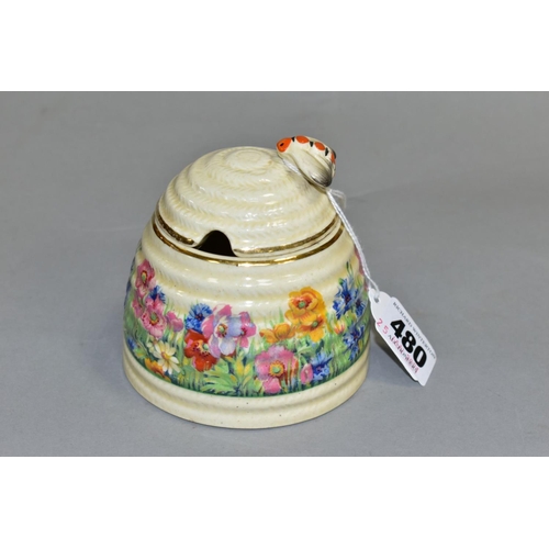 480 - A CLARICE CLIFF FOR NEWPORT POTTERY HONEYPOT AND COVER, with painted bee finial, the body decorated ... 