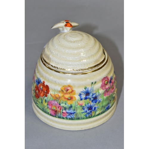 480 - A CLARICE CLIFF FOR NEWPORT POTTERY HONEYPOT AND COVER, with painted bee finial, the body decorated ... 