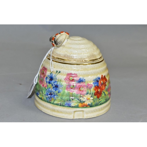 480 - A CLARICE CLIFF FOR NEWPORT POTTERY HONEYPOT AND COVER, with painted bee finial, the body decorated ... 