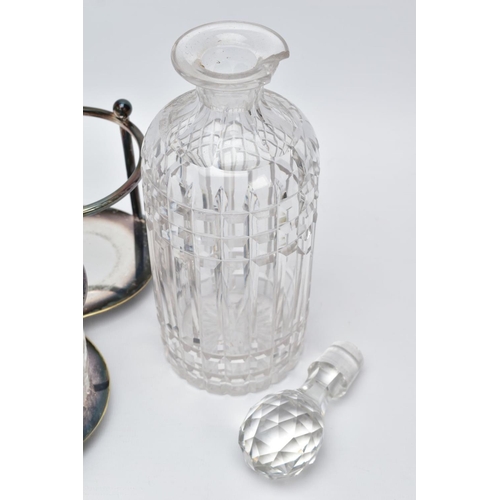 61 - A CUT GLASS THREE BOTTLE DECANTER STAND AND CRUET SET, the white metal decanter set with three cut g... 