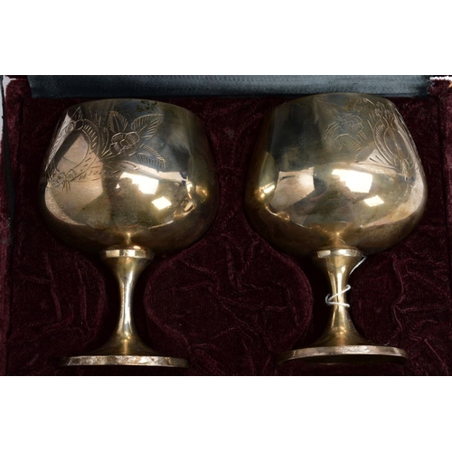 75 - THREE CASED SETS OF WINE AND BRANDY METAL GOBLETS, assorted design each engraved in a foliate and fl... 