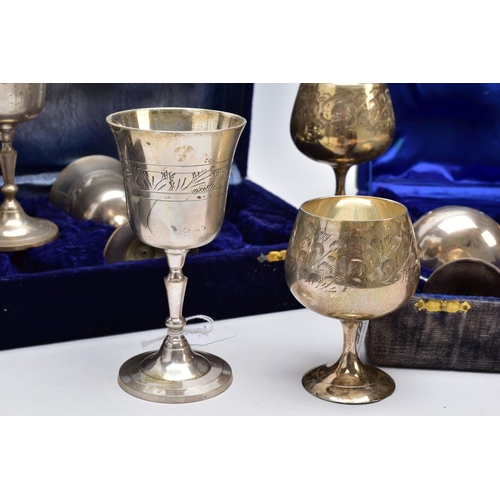 75 - THREE CASED SETS OF WINE AND BRANDY METAL GOBLETS, assorted design each engraved in a foliate and fl... 