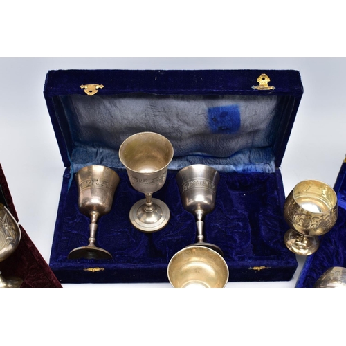 75 - THREE CASED SETS OF WINE AND BRANDY METAL GOBLETS, assorted design each engraved in a foliate and fl... 