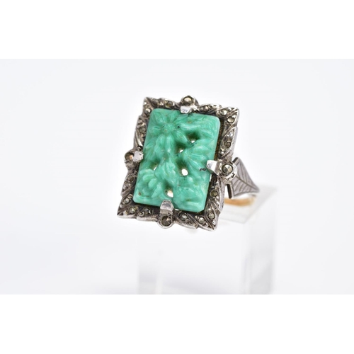 8 - A MARCASITE RING, of rectangular form set with a carved floral green and white central panel within ... 