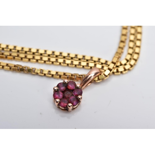 1 - A YELLOW METAL RUBY PENDANT ON  A YELLOW METAL CHAIN, the pendant of circular form set with seven ci... 