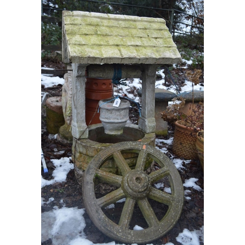 1012 - A COMPOSITE GARDEN WELL 104cm high and a wheel (2)