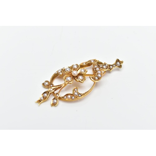 104 - A YELLOW METAL SEED PEARL PENDANT, of an openwork design, featuring a central flower set with a seed... 