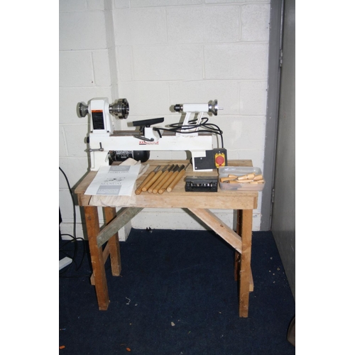 1065 - AN AXMINSTER APTC M330 WOOD LATHE total length 68cm with mandrill chuck, a set of six chisels and go... 