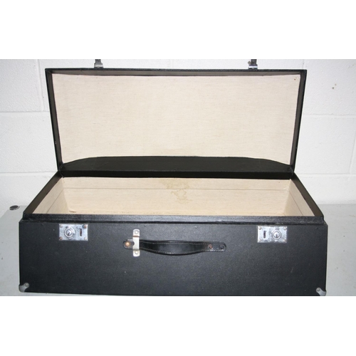 1164 - A SHAPED SMALL CAR SUITCASE with angled front and back and a partially domed top, handle and two cla... 