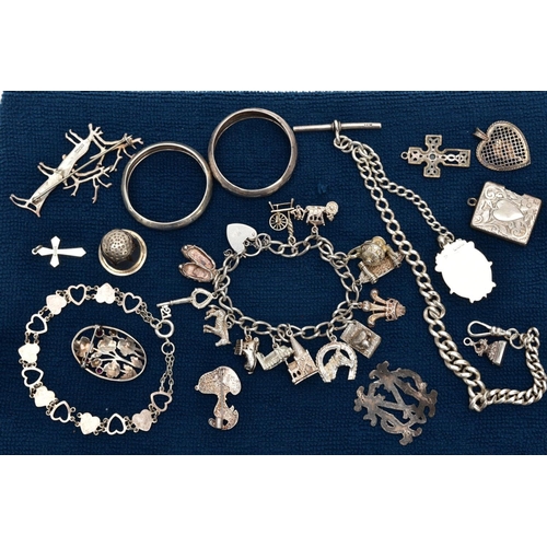 121 - A SELECTION OF SILVER AND WHITE METAL ITEMS, to include a silver charm bracelet suspending thirteen ... 