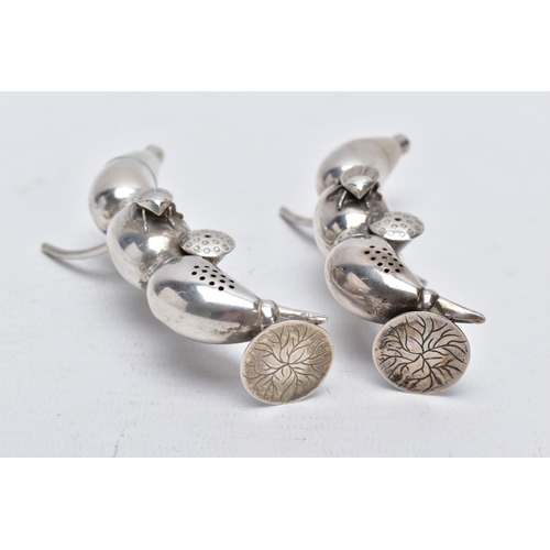 127 - A PAIR OF EARLY 20TH CENTURY CHINESE SILVER PEPPERETTES, in the form of bean or seed pods, each with... 