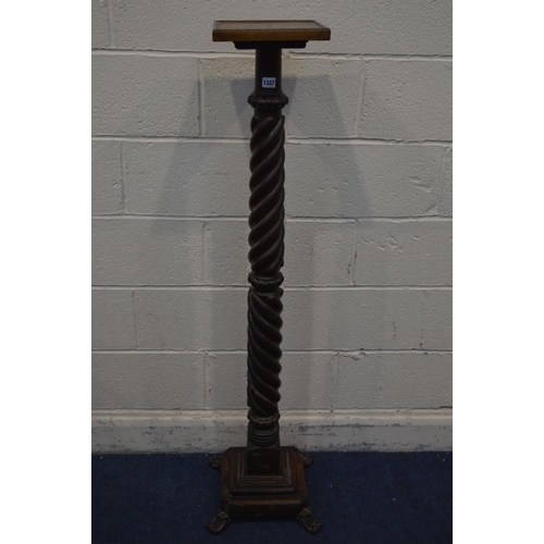 1337 - AN EARLY 20TH CENTURY OAK DOUBLE BARLEY TWIST TORCHERE STAND, on a stepped base and four scrolled le... 