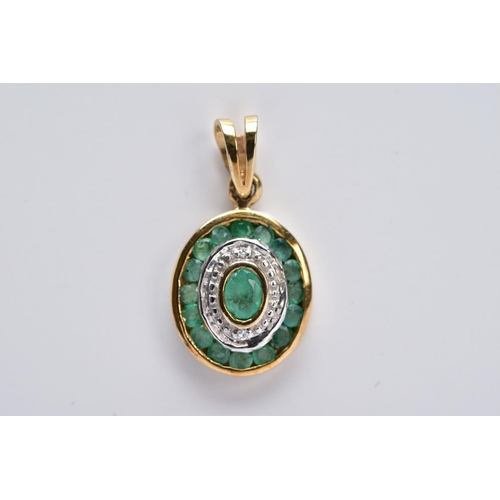 23 - A 9CT GOLD EMERALD AND DIAMOND PENDANT, of an oval form set with a central oval cut emerald within a... 