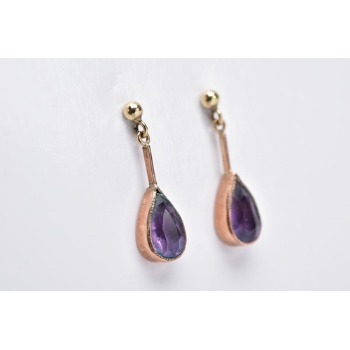 24 - A PAIR OF 9CT GOLD AMETHYST DROP EARRINGS, each designed with a pear cut amethyst within a collet mo... 