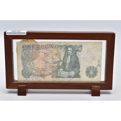 29 - A FRAMED BANK OF ENGLAND 'ONE POUND NOTE', within a wooden frame, raised on two block feet, the note... 