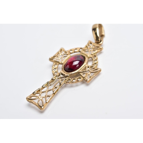 3 - A 9CT GOLD CELTIC CROSS PENDANT, of an openwork design set with a central red paste cabochon fitted ... 