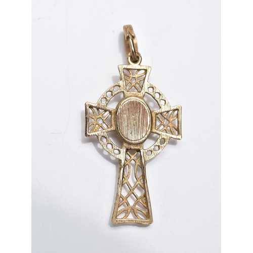 3 - A 9CT GOLD CELTIC CROSS PENDANT, of an openwork design set with a central red paste cabochon fitted ... 