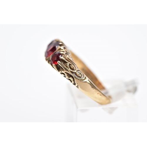 33 - A LATE 20TH CENTURY 9CT GOLD, THREE STONE GARNET RING, designed with three graduated circular cut ga... 