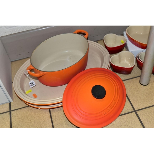 360 - A COLLECTION OF LE CREUSET COOKWARE, comprising an orange enamelled cast iron oval casserole, twin h... 