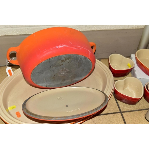 360 - A COLLECTION OF LE CREUSET COOKWARE, comprising an orange enamelled cast iron oval casserole, twin h... 