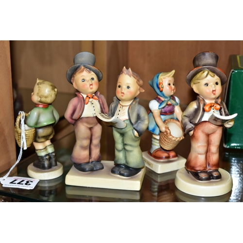 377 - FOUR HUMMEL FIGURES AND TWO DISPLAY STANDS, 'Village Boy' HUM51, 'Little Helper' HUM73, 'Duet' HUM13... 