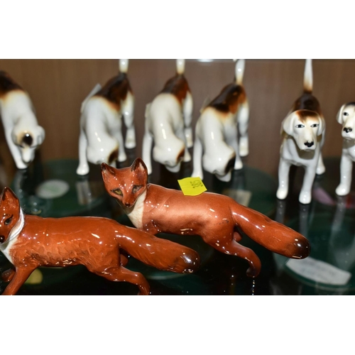 385 - BESWICK FOXES AND FOXHOUNDS, comprising two foxes No 1440 (leg reglued on one), two foxhounds No 941... 