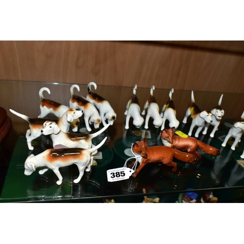 385 - BESWICK FOXES AND FOXHOUNDS, comprising two foxes No 1440 (leg reglued on one), two foxhounds No 941... 