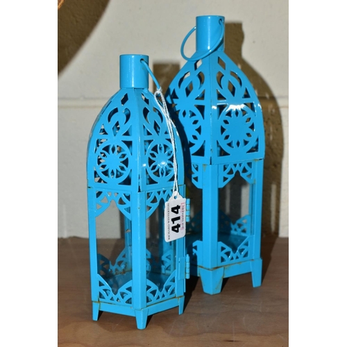 414 - A SET OF SEVEN TURQUOISE PAINTED TEA LIGHT HOLDERS, of Middle Eastern lantern style, three height 24... 