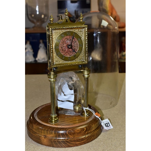 427 - A MID 20TH CENTURY BRASS ANNIVERSARY CLOCK, pendulum loose, mounted on a circular oak base and with ... 