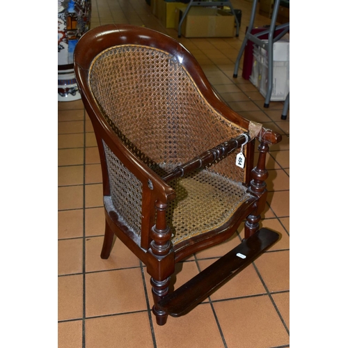 454 - A LATE 19TH CENTURY MAHOGANY CHILDS ARM CHAIR, with Bergere seat and back, removable foot rest, (con... 