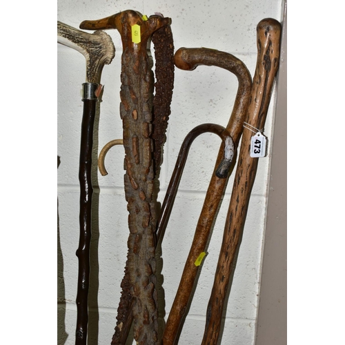 473 - A BUNDLE OF SIX LATE VICTORIAN/20TH CENTURY WALKING STICKS/CANES, an umbrella and a teacher's cane, ... 