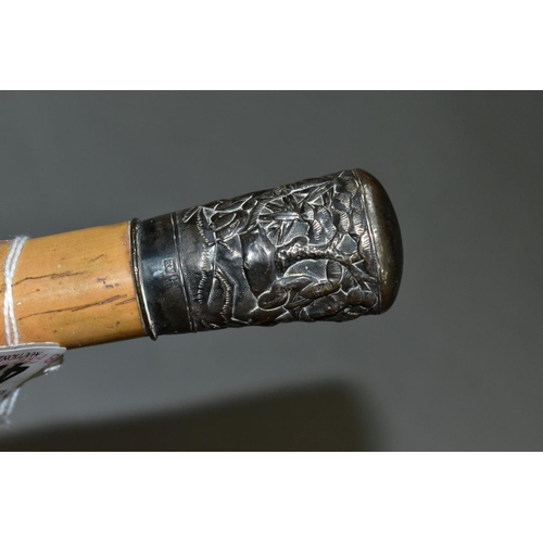 474 - A LATE 19TH CENTURY CHINESE SILVER MOUNTED MALACCA WALKING STICK, the silver repousse decorated with... 