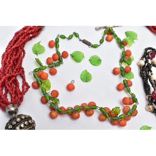 57 - THREE GLASS BEAD NECKLACES, to include a green glass leaf and orange ball bead necklace on a white m... 