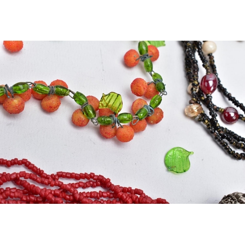 57 - THREE GLASS BEAD NECKLACES, to include a green glass leaf and orange ball bead necklace on a white m... 