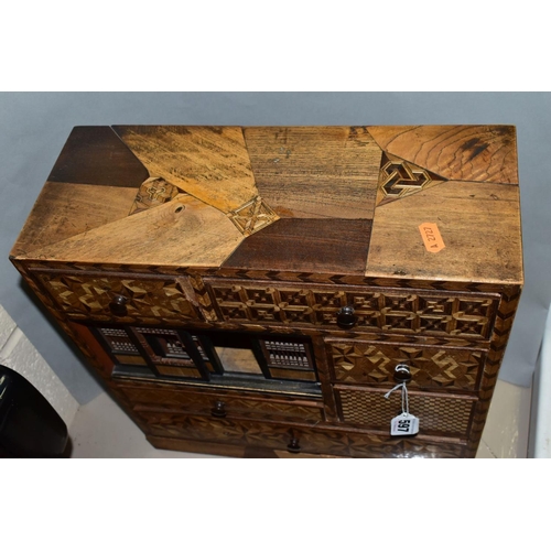 597 - A WOODEN PARQUETRY SPECIMEN BOX, five various sized draws and aperture with sliding pierced panels, ... 