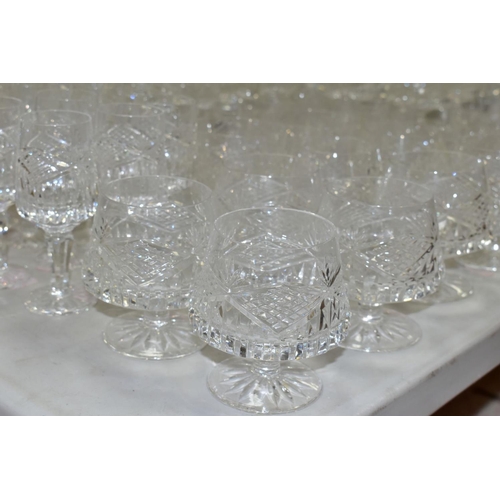 625 - A MATCHED SUITE OF CUT GLASS DRINKING GLASSES, together with a pair of conical shaped decanters, to ... 