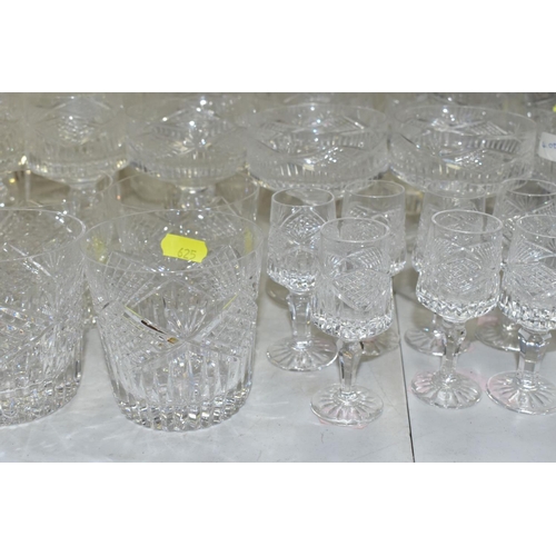 625 - A MATCHED SUITE OF CUT GLASS DRINKING GLASSES, together with a pair of conical shaped decanters, to ... 