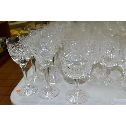 625 - A MATCHED SUITE OF CUT GLASS DRINKING GLASSES, together with a pair of conical shaped decanters, to ... 