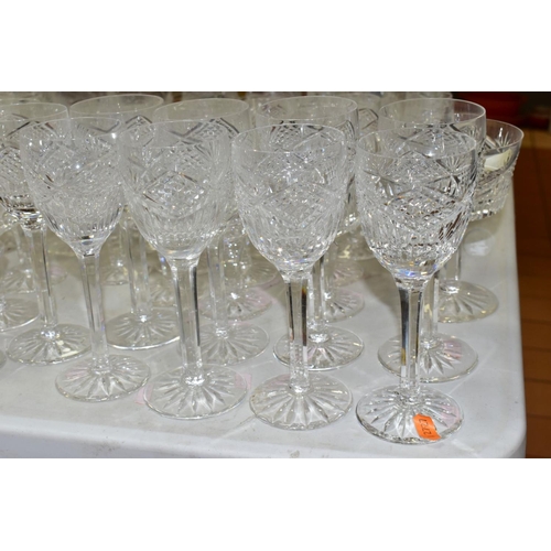 625 - A MATCHED SUITE OF CUT GLASS DRINKING GLASSES, together with a pair of conical shaped decanters, to ... 