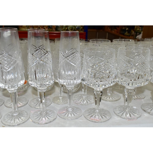 625 - A MATCHED SUITE OF CUT GLASS DRINKING GLASSES, together with a pair of conical shaped decanters, to ... 