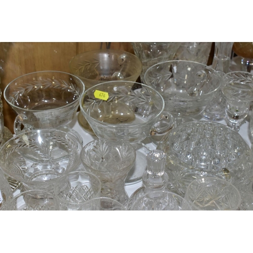 676 - A QUANTITY OF GLASSWARE, including drinking glasses, bowls, jugs, decanters, rose bowls, vases, perf... 