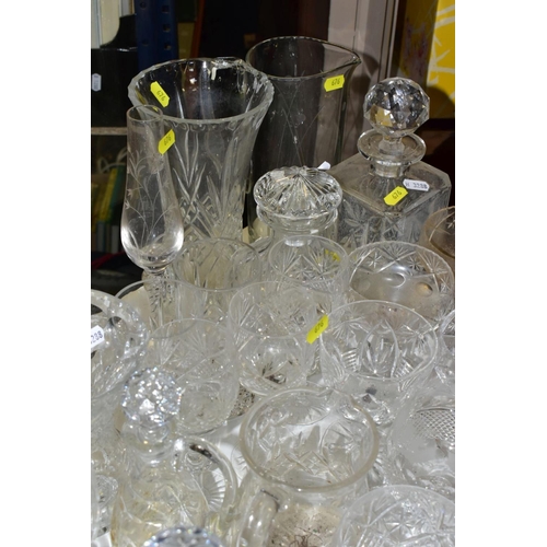 676 - A QUANTITY OF GLASSWARE, including drinking glasses, bowls, jugs, decanters, rose bowls, vases, perf... 