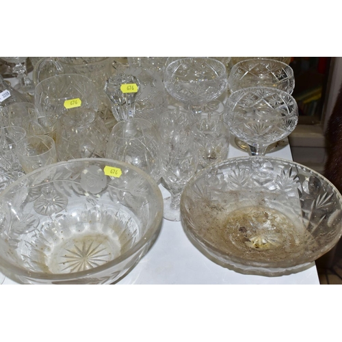 676 - A QUANTITY OF GLASSWARE, including drinking glasses, bowls, jugs, decanters, rose bowls, vases, perf... 