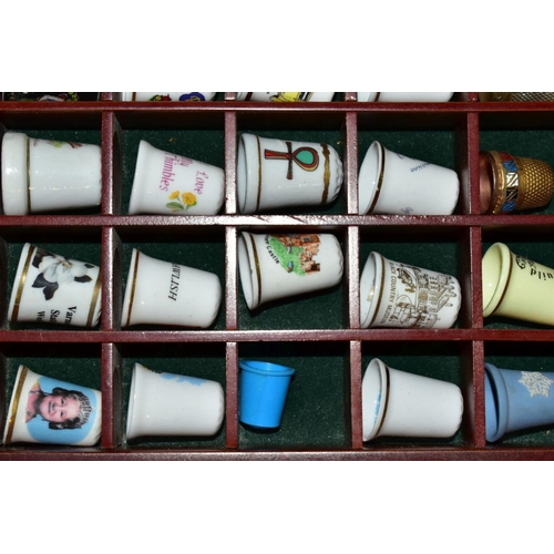 678 - THREE WOODEN DISPLAY SHELVES OF METAL AND CERAMIC THIMBLES AND SOUVENIR SPOONS, together with a smal... 